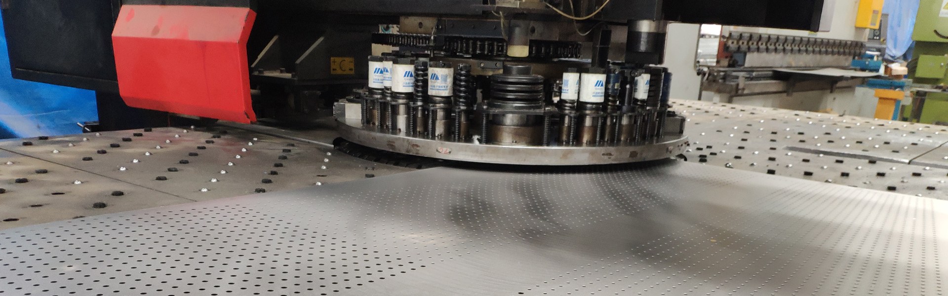 A machine is producing perforated mesh sheets.